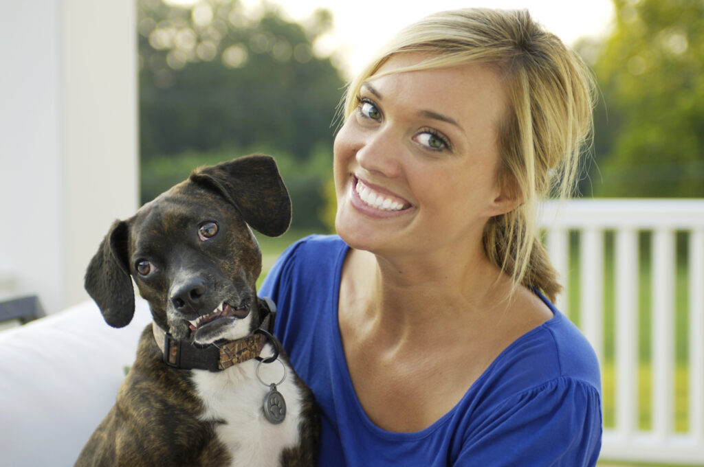 patient wearing Invisalign and holding her dog